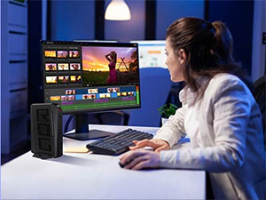 Lifestyle image of a woman using the mini pc with a monitor