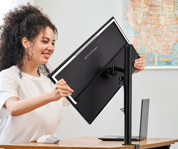 Woman adjusting monitor to C-clamp