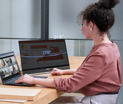 Lady multitasking on laptop and monitor