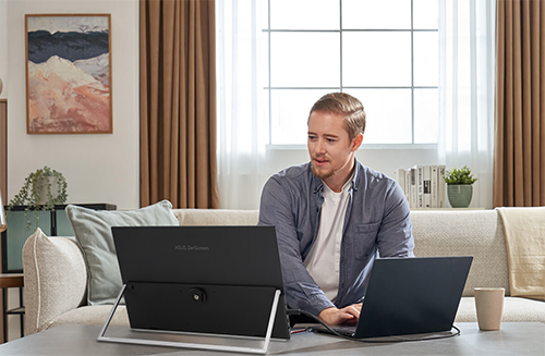 Man working from home on laptop and portable monitor
