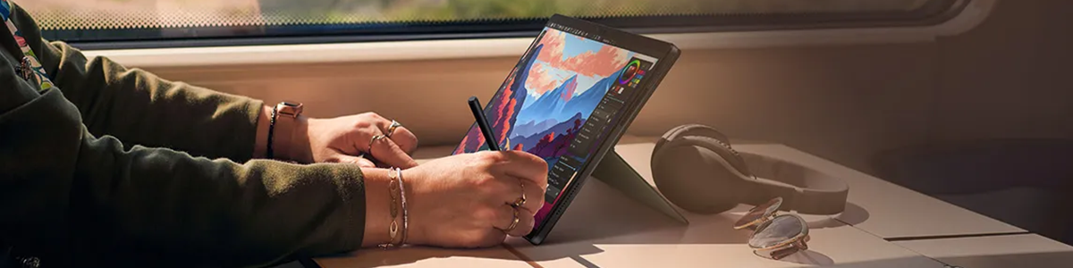 Lifestyle scenario of artist working on a graphics table at a desk.
