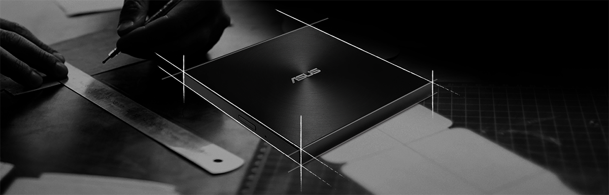 Image of the ZenDrive on a table with an artist drawing and measuring in the background