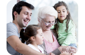 Lifestyle photo of a family viewing photos together on laptop