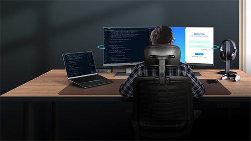 Image of man using monitors in a desktop setup