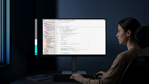 Woman working on BenQ Programming Monitor at night with brightness control bar illustration aside.