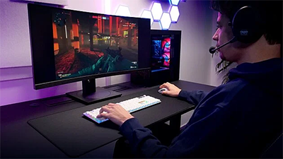 Person playing a game using the XTRFY keyboard
