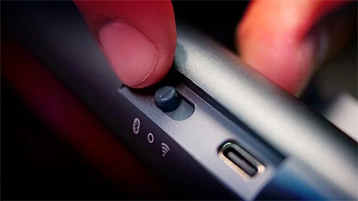 Connectivity switch on the XTRFY being operated by a thumb