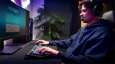 Side view of PC gamer, using the XTRFY to play a game