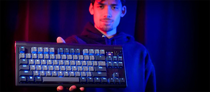 Person holding keyboard outwards in one hand to showcase premium design
