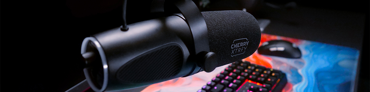 XTRFY NGALE X microphone on boom arm with keyboard and mouse close by. 