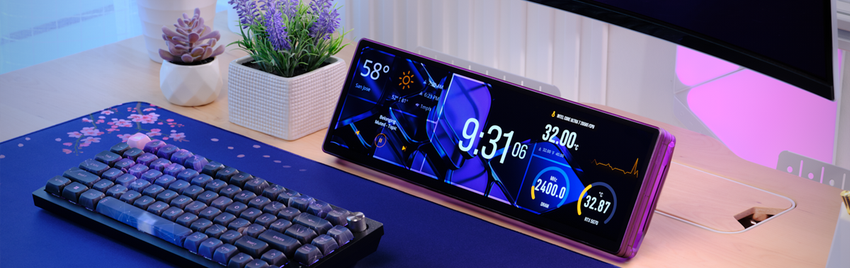 Scenario of XENEON EDGE LCD Touchscreen on a desktop, under a monitor beside various peripherals.