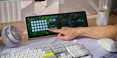 Xeneon Edge LCD display underneath monitor displaying movie.