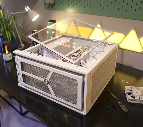 Image of case on a desktop next to fans and screws in a building setting
