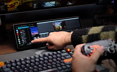 view of person in jumper browsing Spotify and Premier Pro on XENON edge