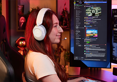 lady wearing white headphones while gaming