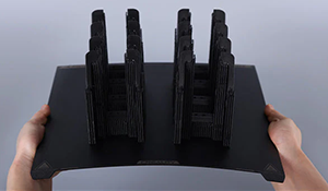 Flexible build plate held in two hands.
