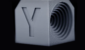 Motion Advance feature demonstrated on a 3D printed cube, showcasing precise embossed details.