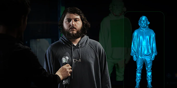 Man being scanned by CR-Scan Raptor scanner with 3D model of him overlayed aside.