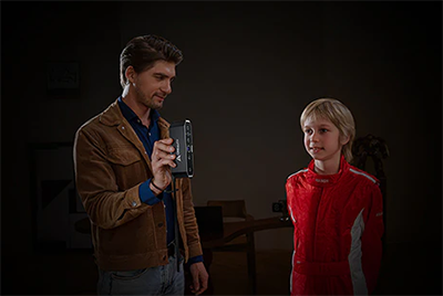 child posing for scan while dad holds the device