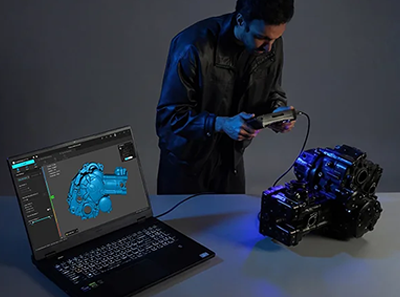 Man connectiong Sermoon P1 3D scanner to laptop and camera via wire.