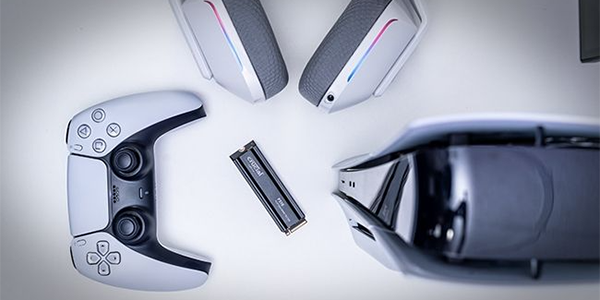 Top down view of P310 M.2 SSD on a white surface surrounded by PS5 peripherals, highlighting PS5 compatibility