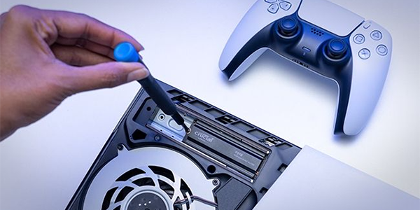 Hand with screwdriver, fixing the P310 M.2 SSD into a PS5, highlighting easy installation