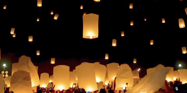 Chinese lanterns illuminating a night sky.