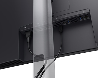 Rear angle of Dell Pro P monitor with power and USB-C cable attached, wires threaded through its stand.