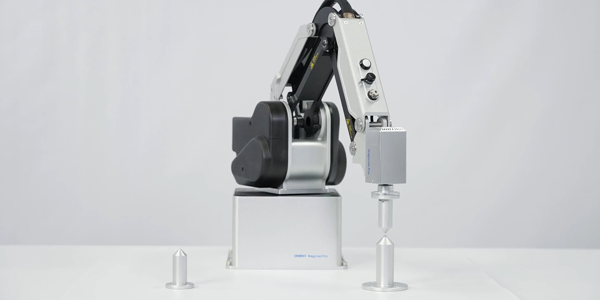 MG400 accurately aligning an attached pointed metal bolt with the point of a bolt on a desk.