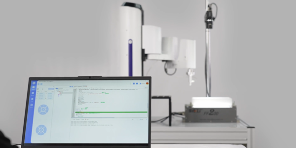 Laptop infront of M1 Pro SCARA robot, highlighting easy operation.