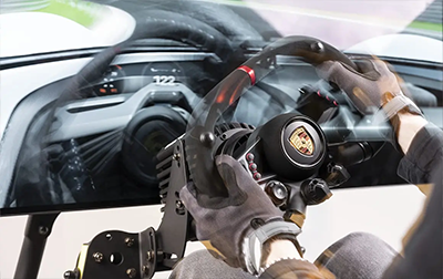 Player in front of Simulator Cockpit frantically steering wheel