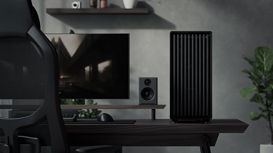 Front facing view of case placed on desk with monitor, speaker and chair visible