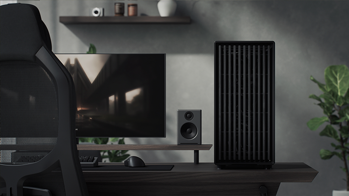 Front facing view of case placed on desk with monitor, speaker and chair visible