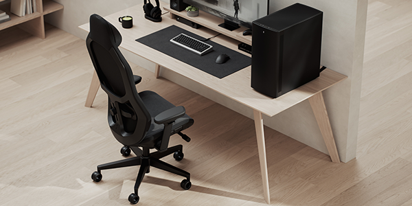 Refine 2 chair next to full desk setup with PC, monitor and peripherals.