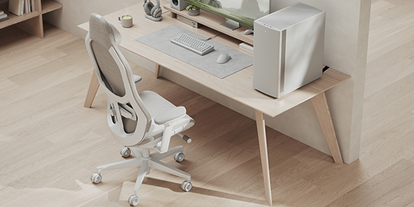 Refine 2 chair next to full desk setup with PC, monitor and peripherals.