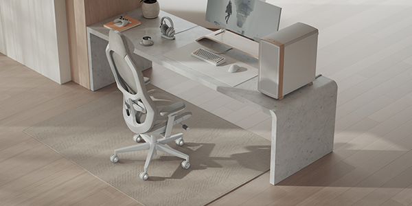 Refine 2 chair next to full desk setup with PC, monitor and peripherals.