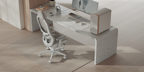 Refine 2 chair next to full desk setup with PC, monitor and peripherals.