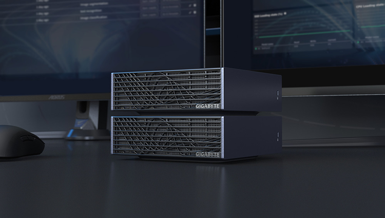 Two Gigabyte AI TOP ATOM SUpercomputers sit stacked on a desk in a working environment