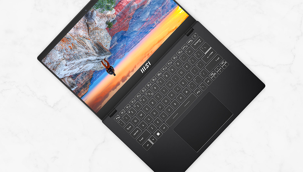 MSI Modern 14 laptop flip-n-share function illustrated on screen via upside down scenic cliff view.