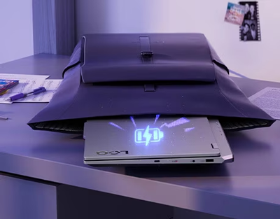 grey leather bag with laptop coming out and charge graphic above it