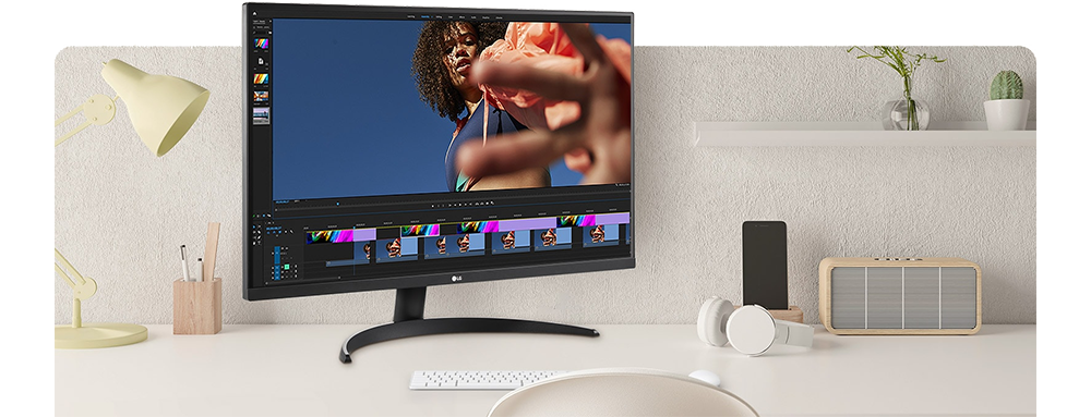 Image of the monitor on a cream desk setup with video editing software on the screen