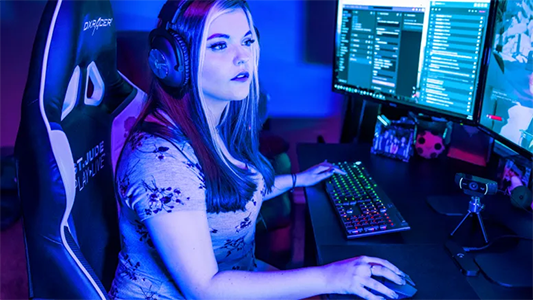 Female streamer gaming on her PC.