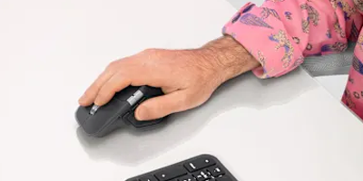 Hand using the MX Master 4 mouse.