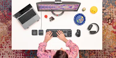 Man working on desktop computer using MX Master 4 mouse.