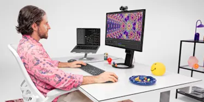 Man working with MX Master 4 mouse on a desktop PC.
