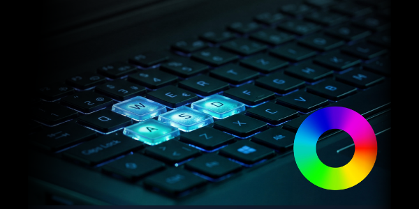 Side angle of keyboard, close up,  with W, A, S and D key illuminated in blue.