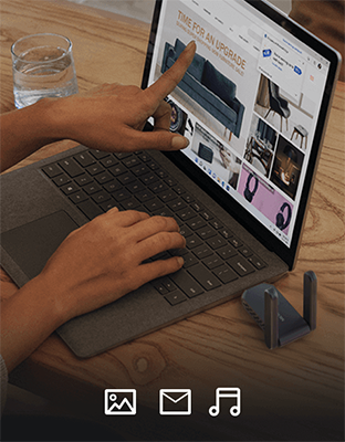 Laptop on desk with user browsing a shopping website.