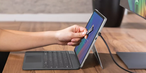Hand holding NFC card to the screen, highlighting passwordless functionality