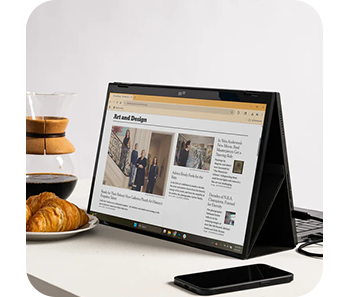 Image of the monitor on a table with a news article on screen