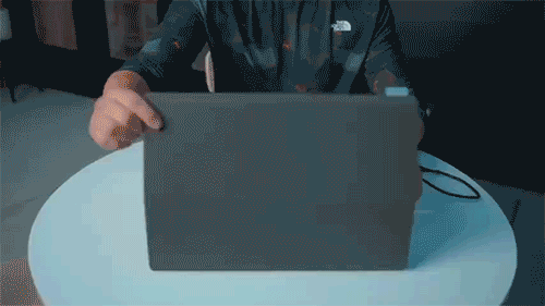 Gif image of a male setting up and plugging in the monitor